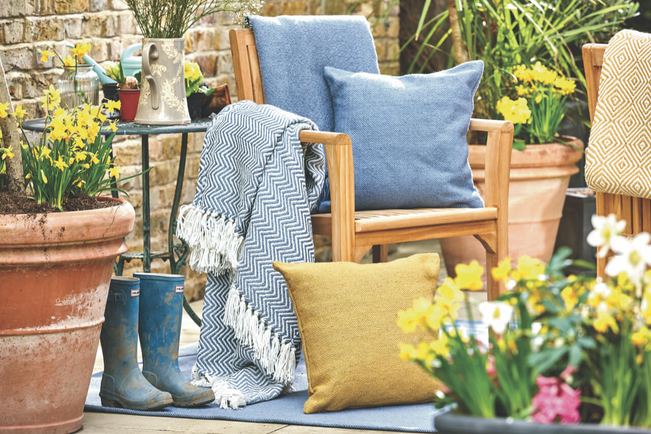 Woven cushions, throws and rugs covering an outdoor area