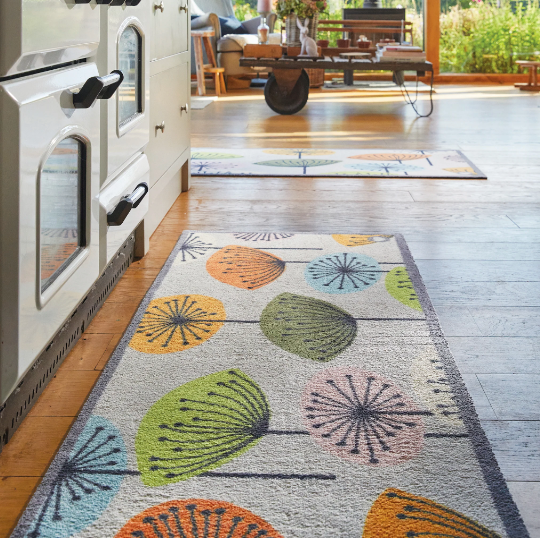 A floral kitchen runner in front of an aga oven