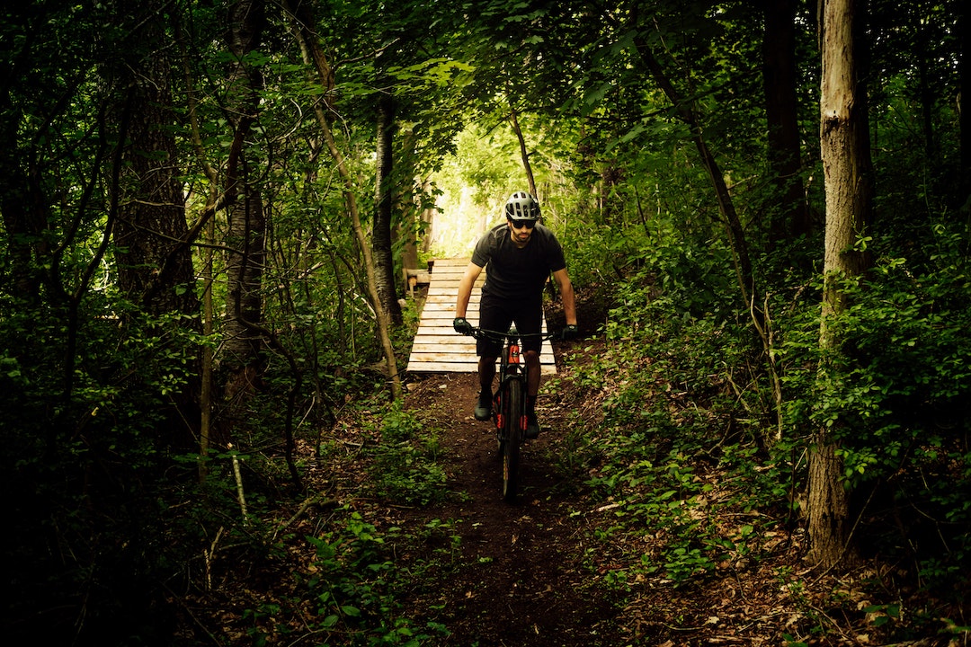 man biking in the woods