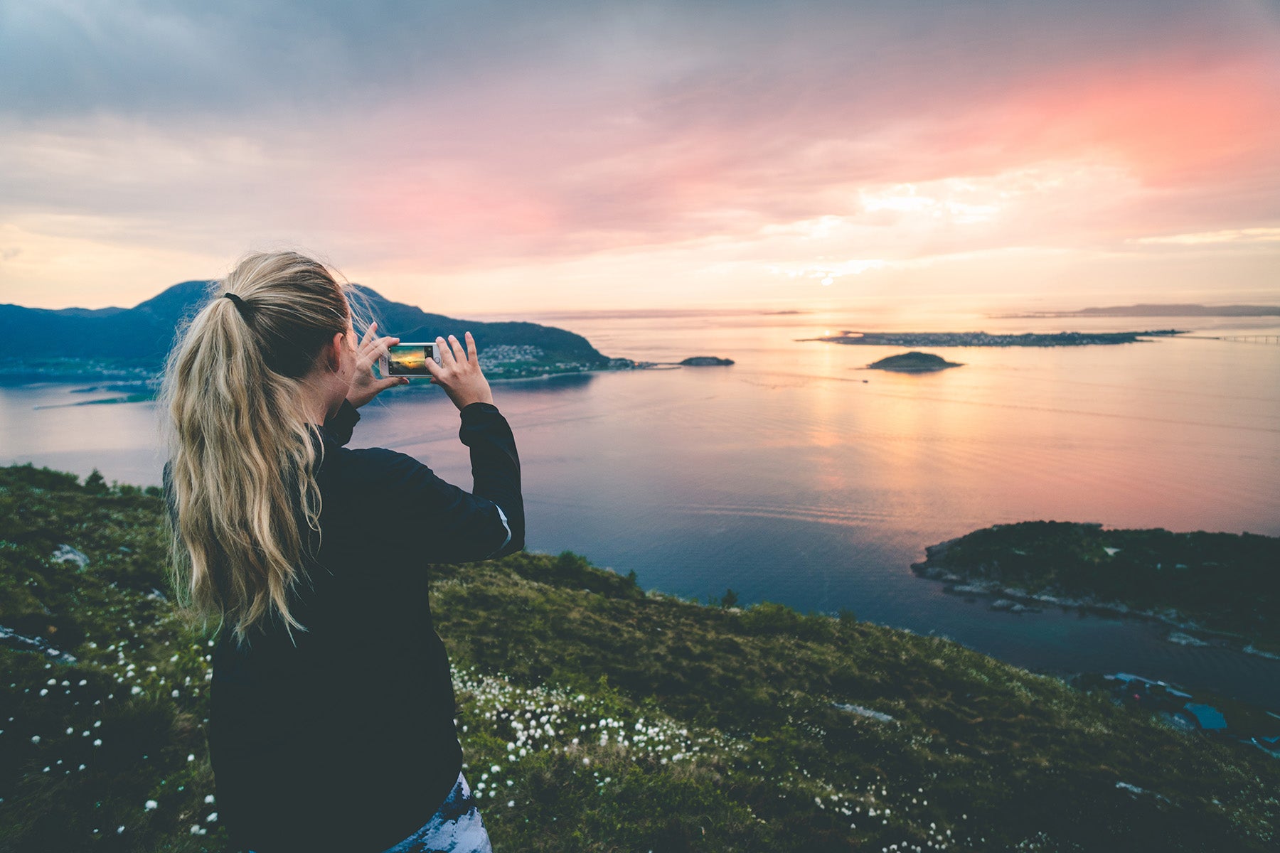 young woman photographing landscape