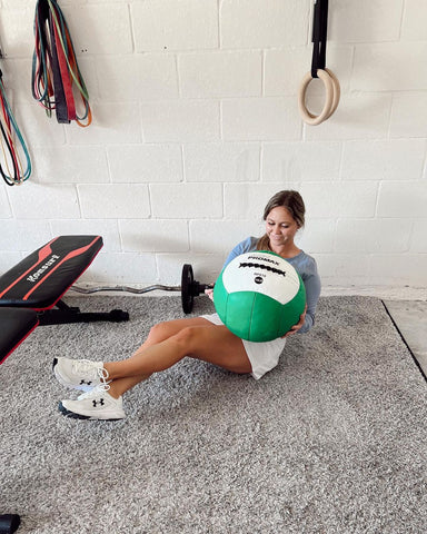 person doing a core workout with a Rhino Medicine Ball