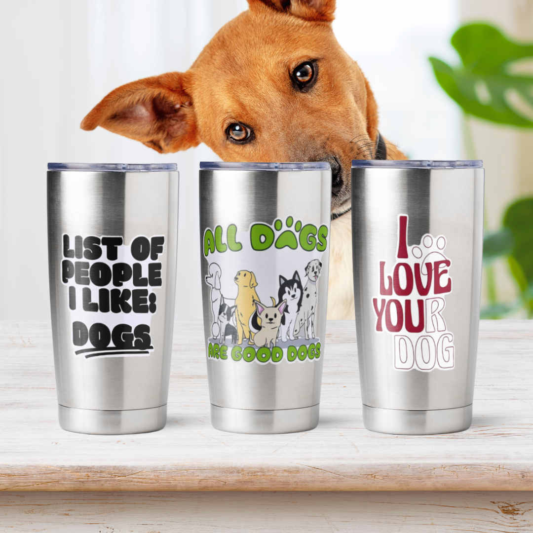 Three tumblers with dog-themed phrases peeked at by a dog.