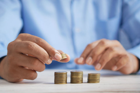 a man is stacking coins on the desk