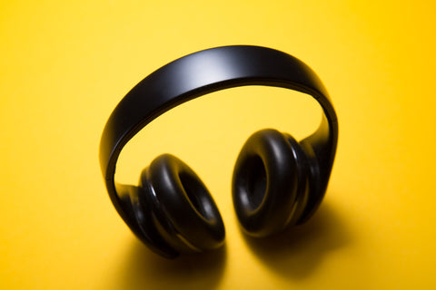 black headphones with yellow background