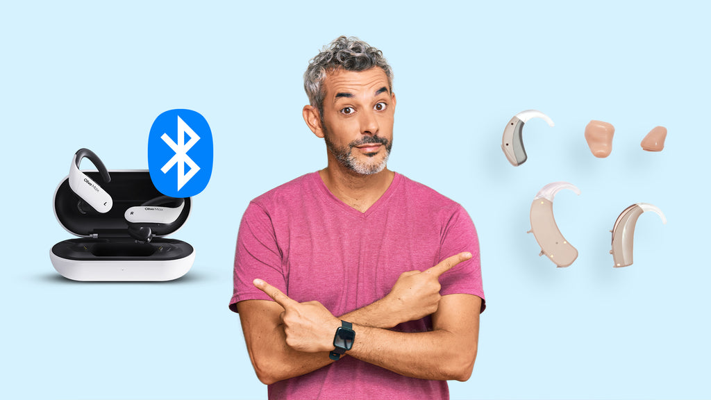 A man is pointing both sides with finger and there are bluetooth hearing aids on left side and there are traditional hearing aids on the right side