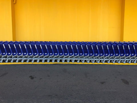 shopping carts have been displayed infront of the yellow brickwalls