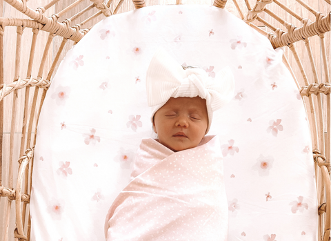 Newborn Sleeping Calmly On Rattan Bassinet