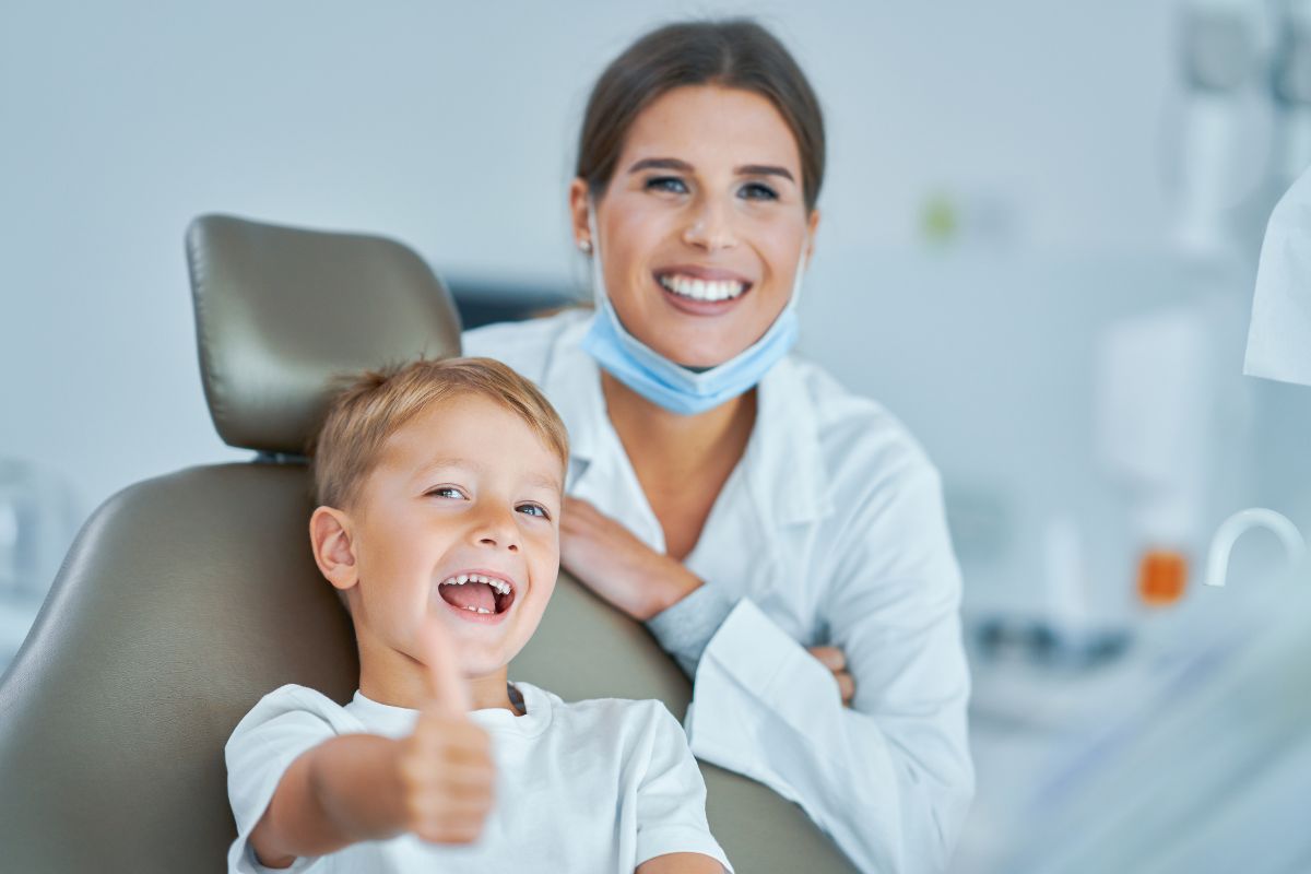 kid with dentist thumbs up