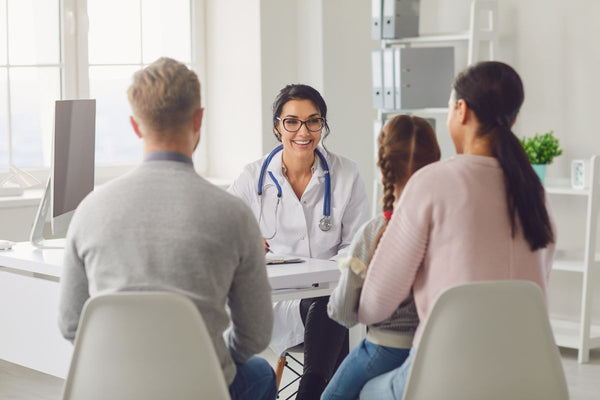 children with parent discussion with doctor