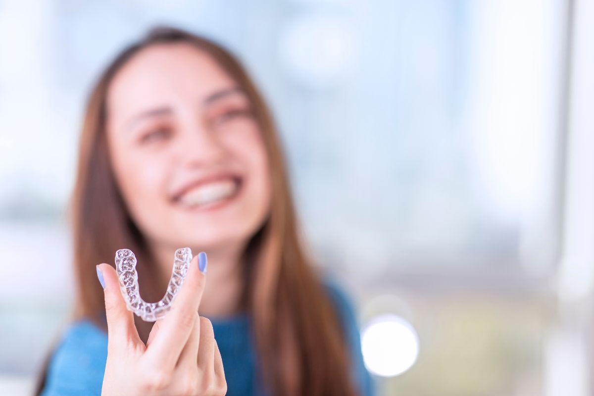 woman showing invisalign braces