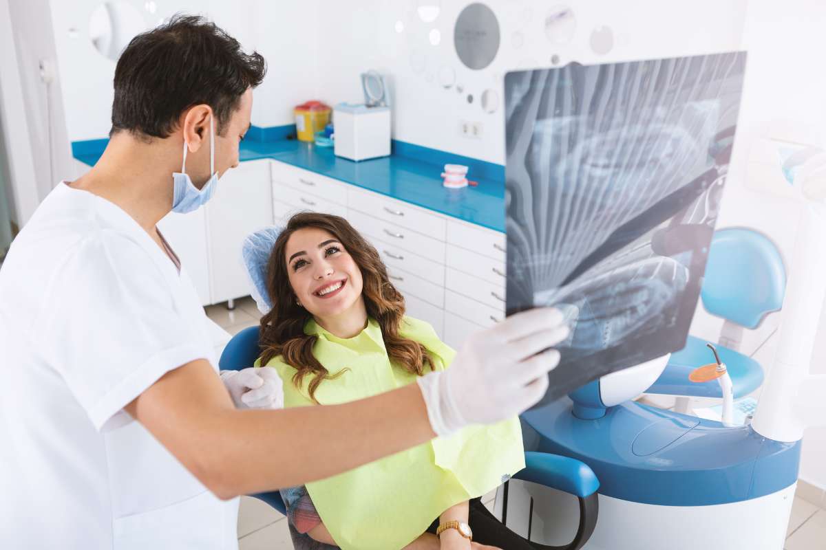 female in clinic showing dental bridges x-ray