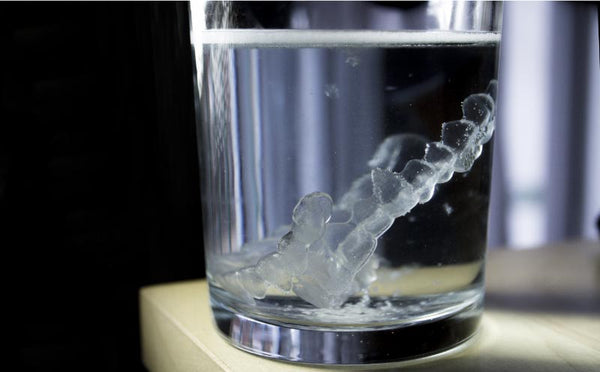 Invisalign aligner soaked in water with Invisalign cleaning crystals