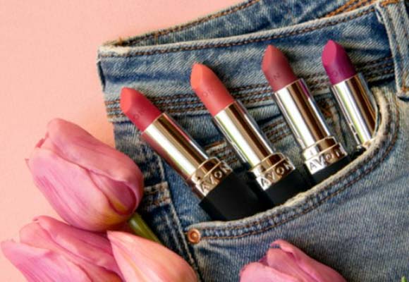 Lipstick range in jeans pocket with tulips.