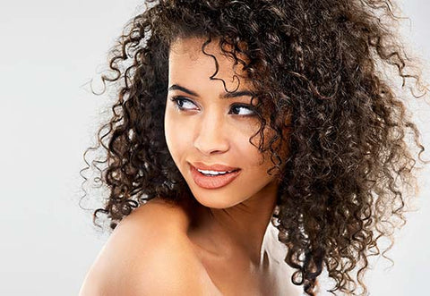 Model with dark curly hair.