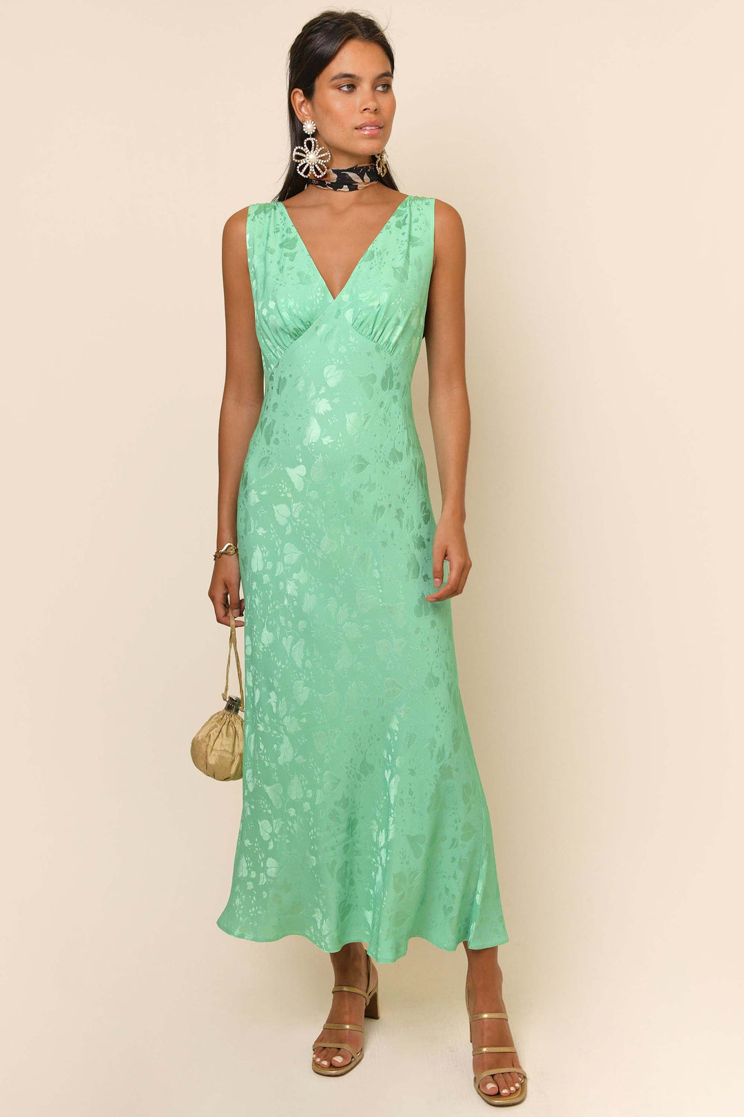 Rixo slinky and sophisticated midi dress in a beautiful aqua / jade green. It has a leaf-patterned weave, empire waistline and bias cut inspired by vintage finds and has timeless appeal. Deep V-neckline with a lined bust that Conceals a bra. Empire waisted with concealed side zipper and an unlined bias skirt. 