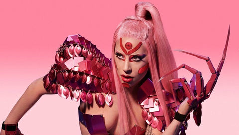 lady gaga on pink background wearing claw nail rings