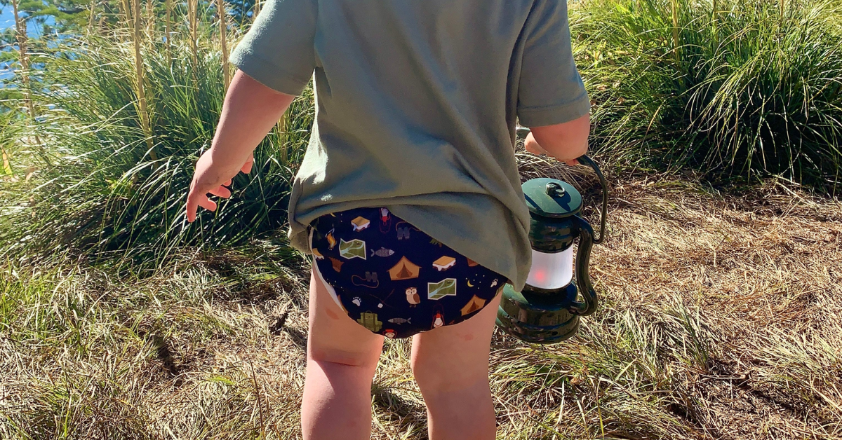 a child is wearing a cloth diaper outside