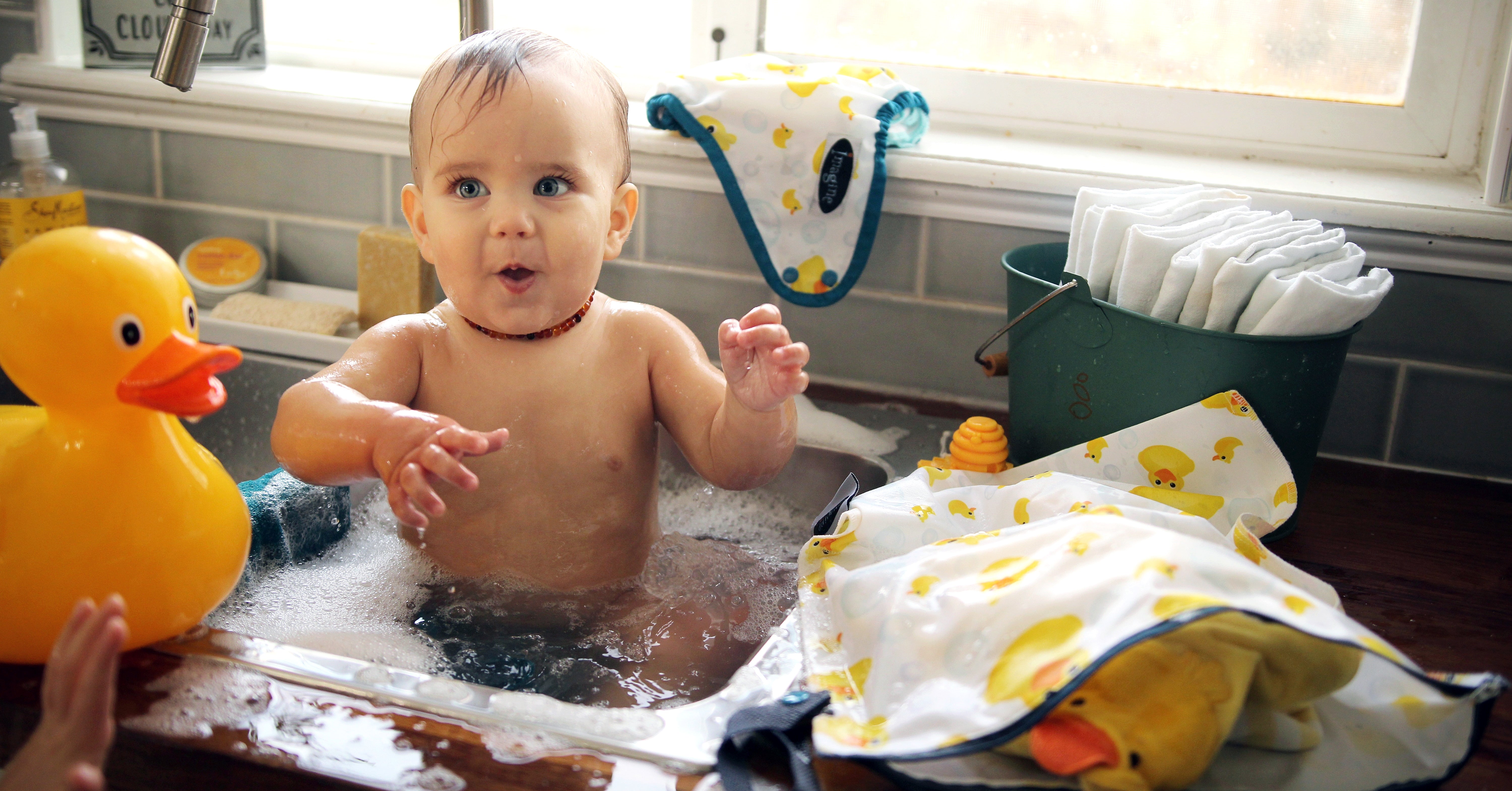 baby bath time in the kitchen sink