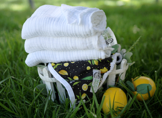 Nicki's Flat Cloth Diapers on top of Lemon Print Cloth Diaper Cover