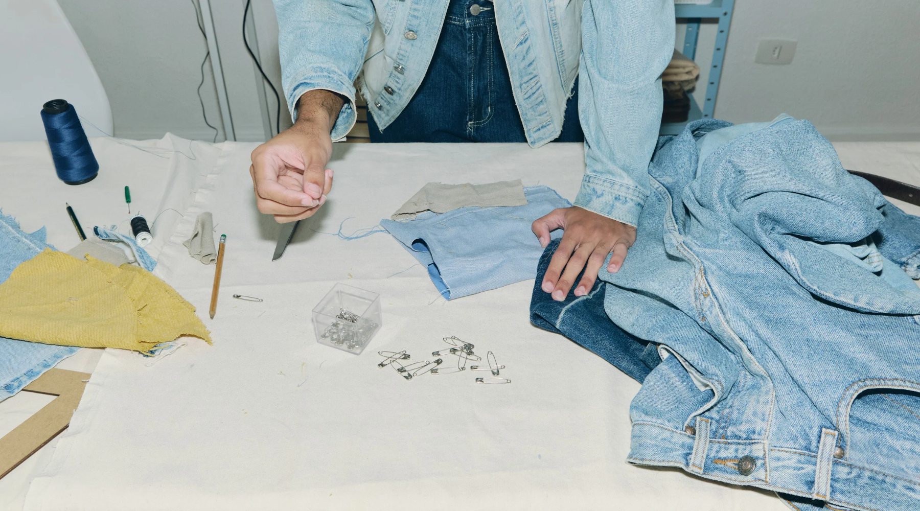 A tailor making something new out of old jeans.