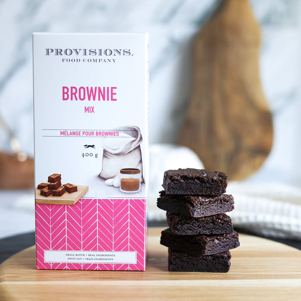 Brownie Dry Mix beside a stack of freshly baked brownies