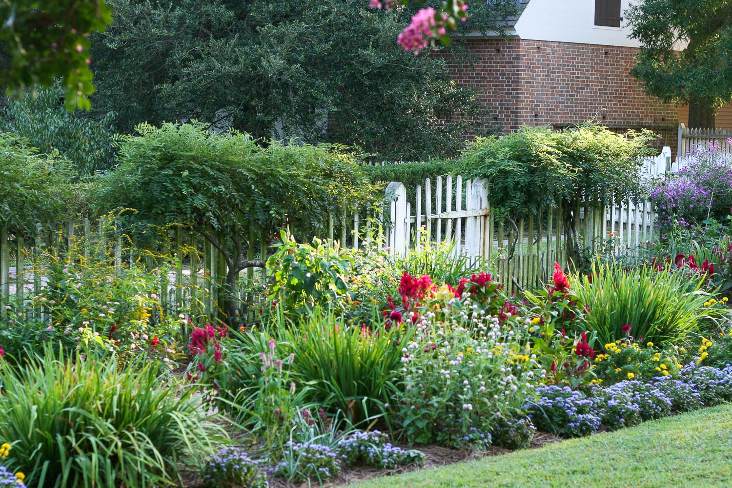 Flower garden at Colonial Williamsburg with white fence