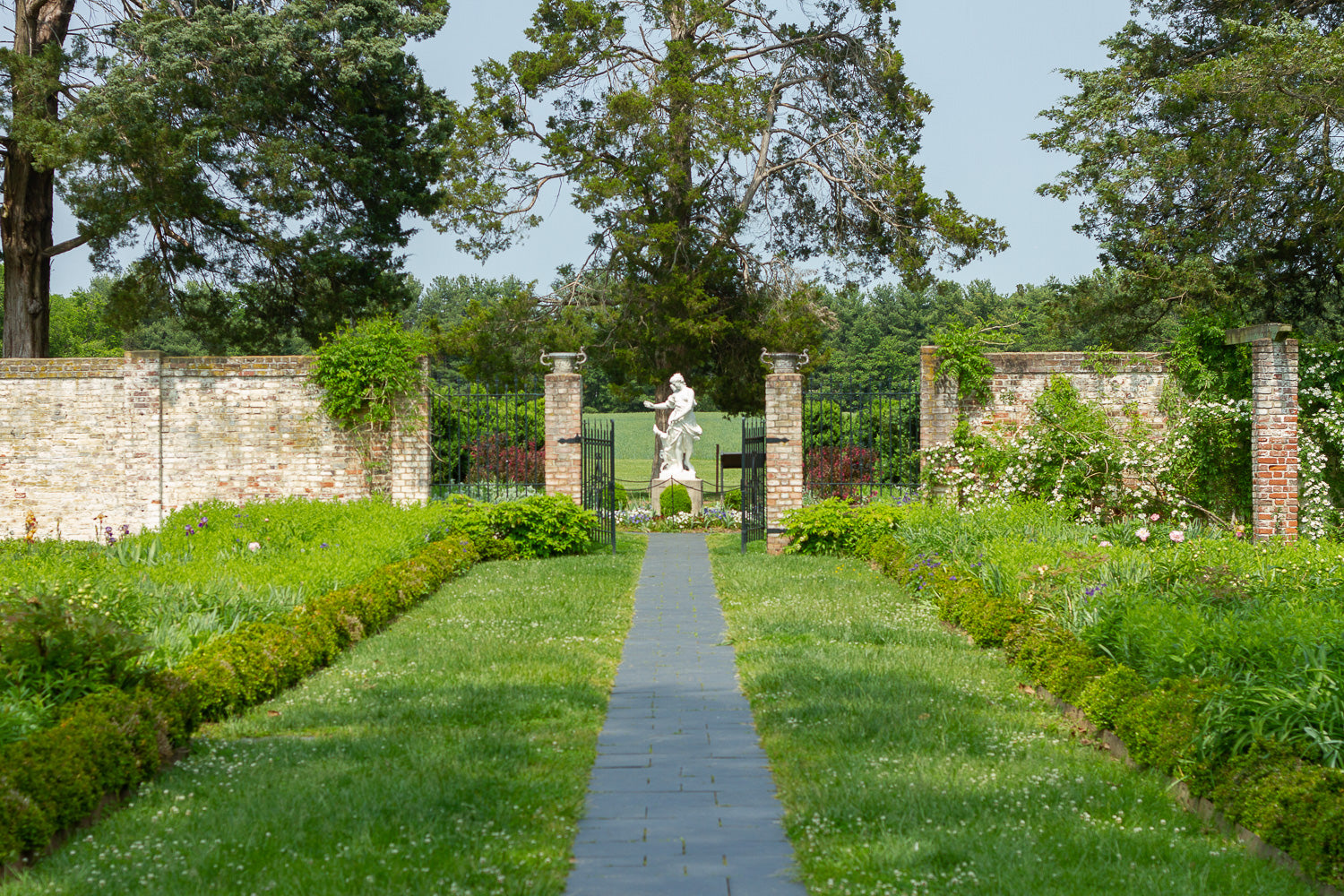 Marble statue in romantic flower garden