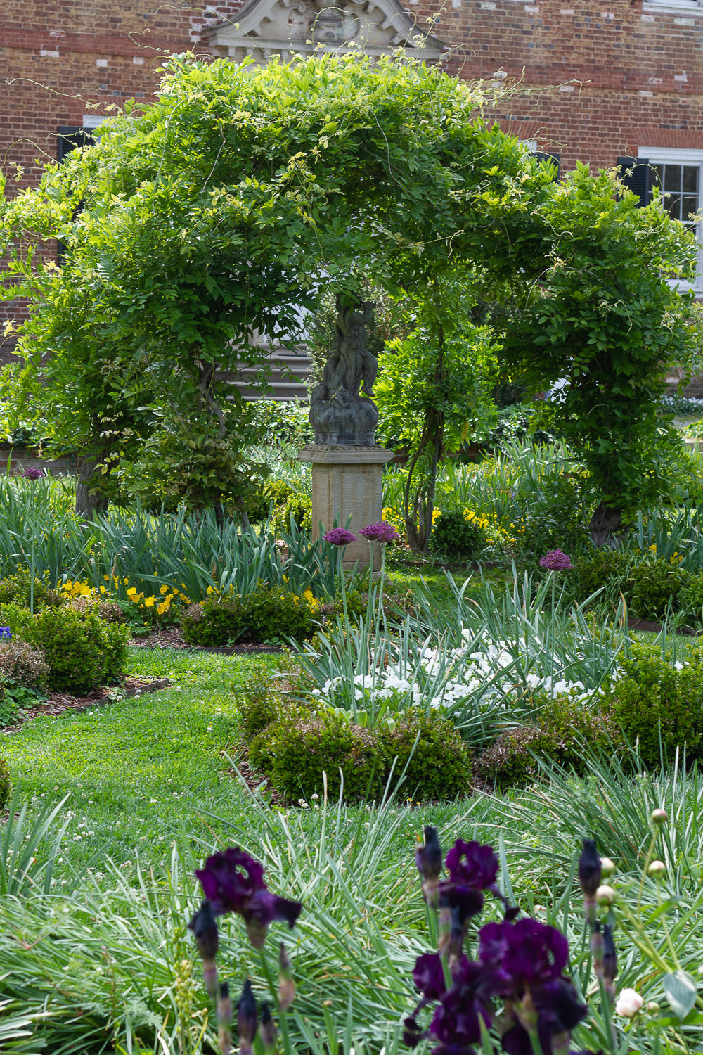 Gardens with statue bower and irises