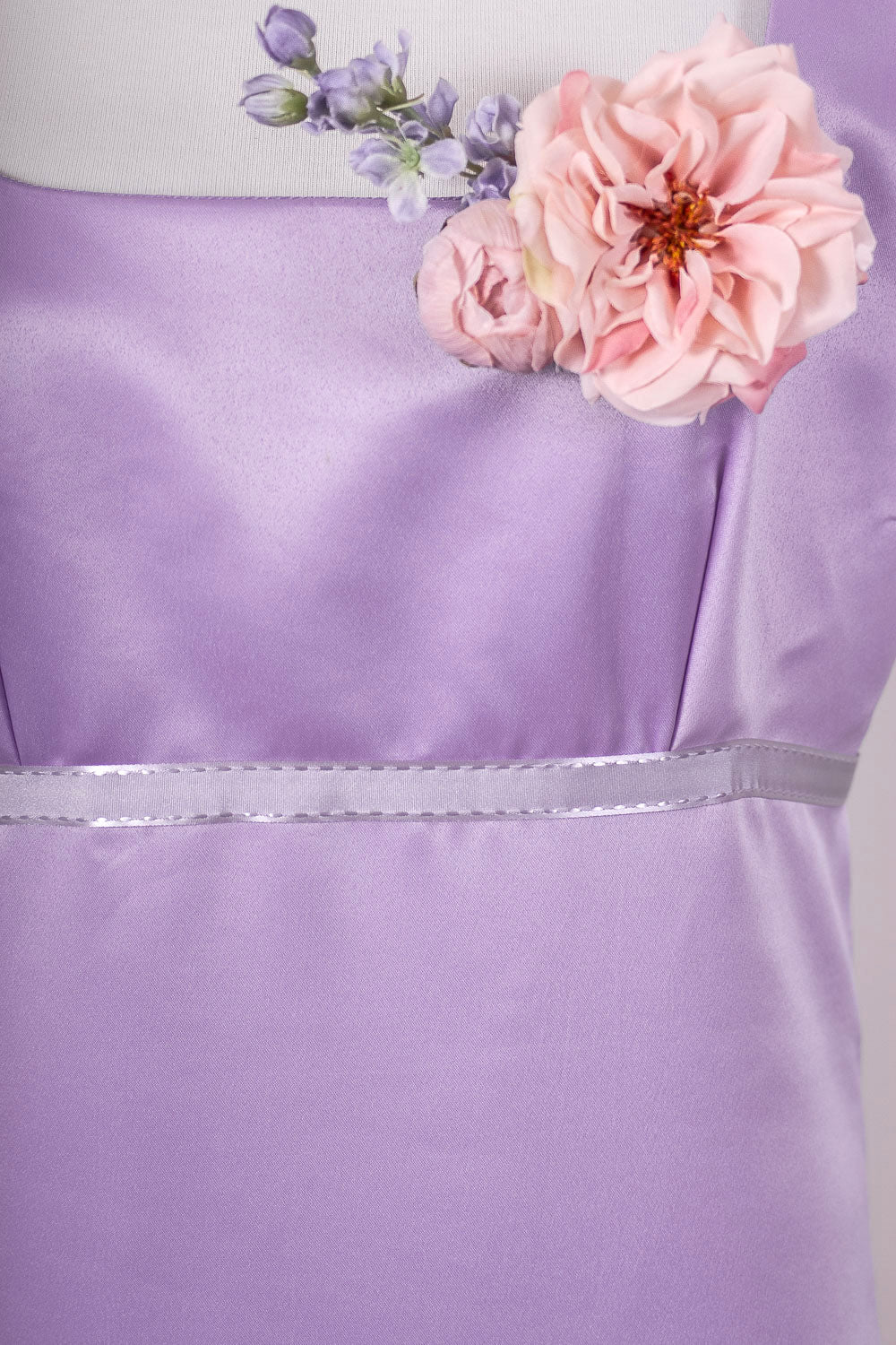 Close up of Purple Regency dress ribbon belt and flowers