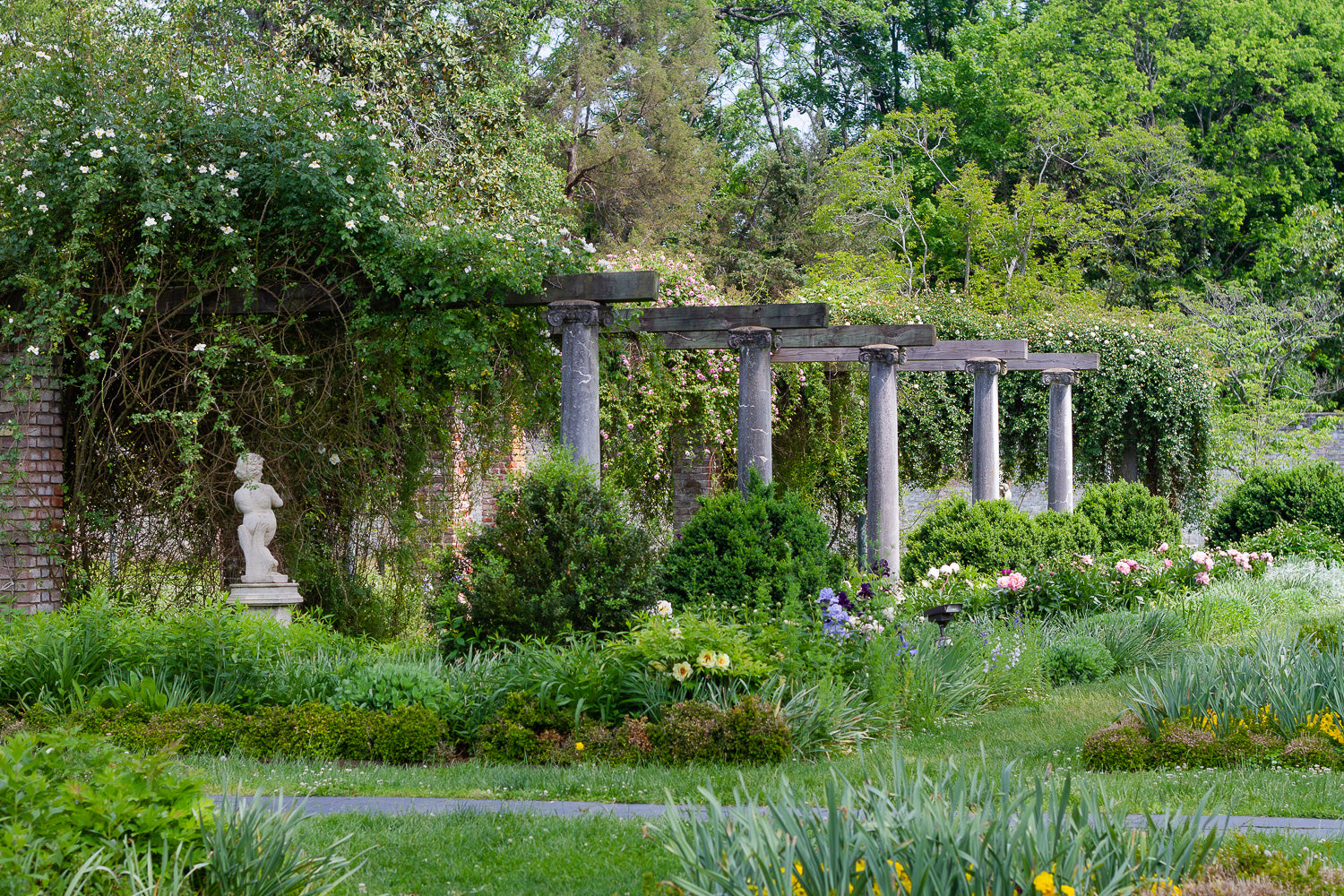 classical garden with statue and flowerbeds