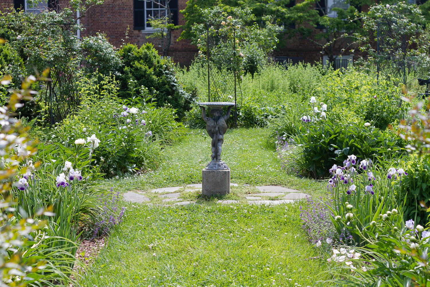 historic garden with statue and flower beds