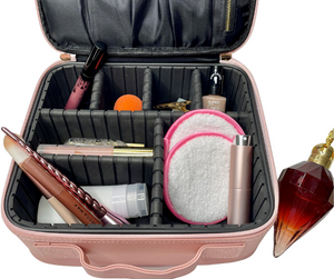 pink travel atomiser wound out, inside a pink cosmetic case with other beauty supplies