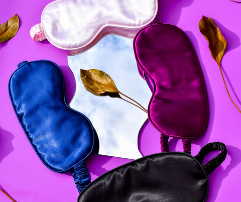 travel sleep/eye masks on a purple background