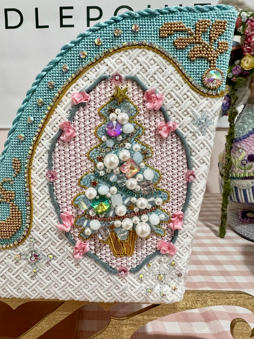 A mid century modern inspired needlepoint ornament by of a bird's head and  stones featuring colors from this era and an easy to stitch design for a  beginner craft project. – Needlepoint