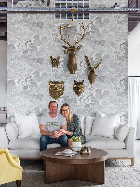 Meg and Joe Piercy sitting on the couch of their newest showroom in Munster, IN