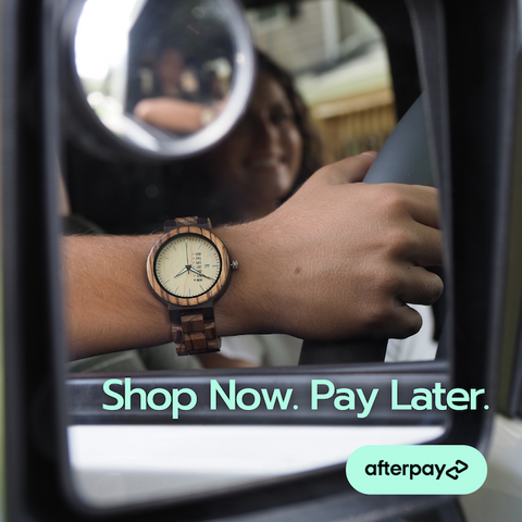 Wooden watch in rearview mirror words "Shop Now. Pay Later. Afterpay"