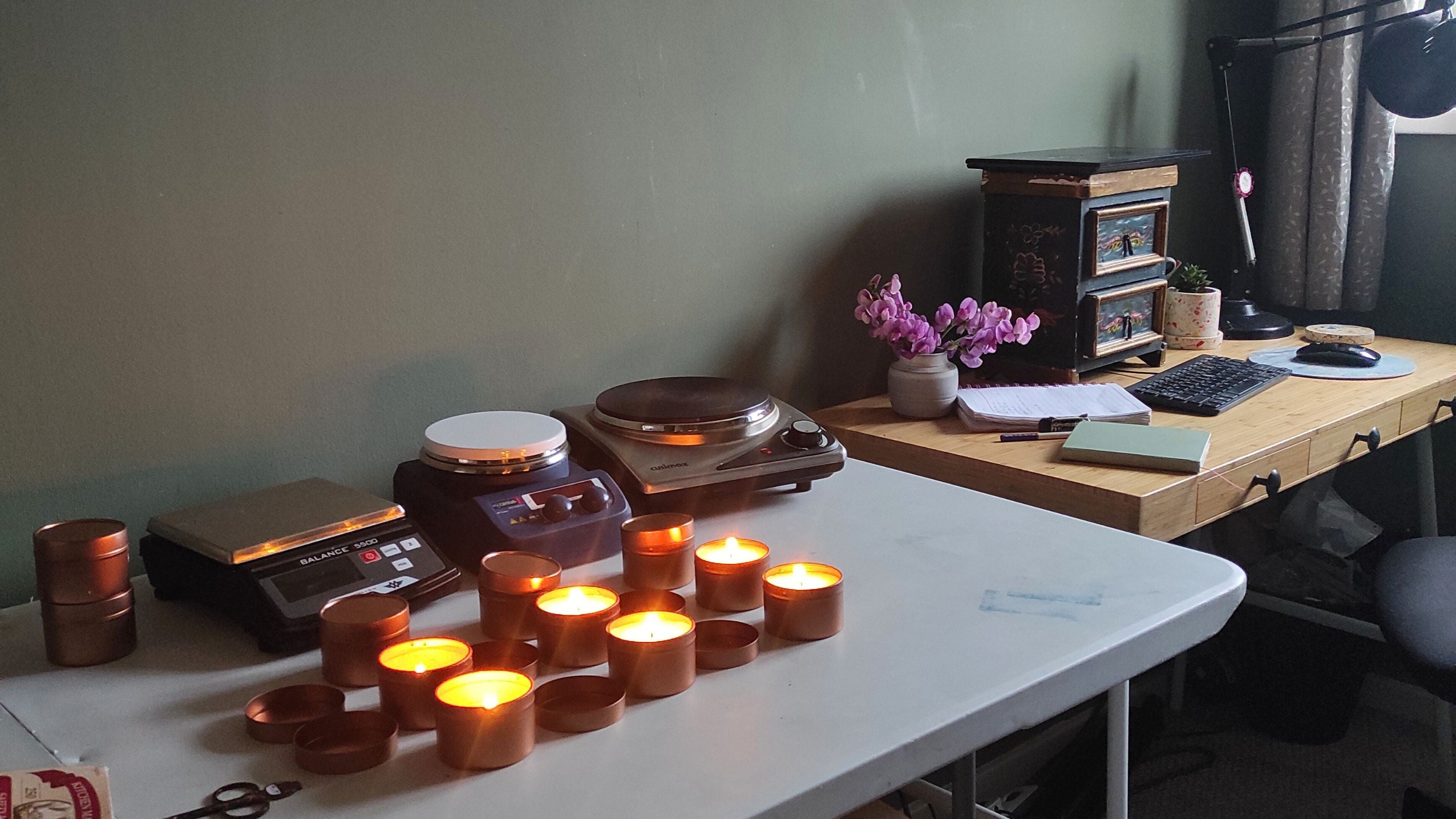 Candle burn testing on table with sweetpeas