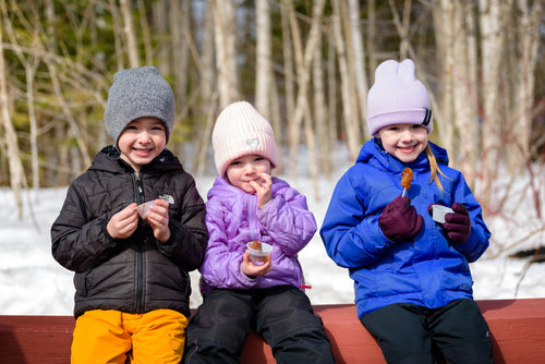 kings landing kids eating maple taffy.jpeg__PID:e403f6d3-0de4-4c39-a42a-ccb272f6b22c