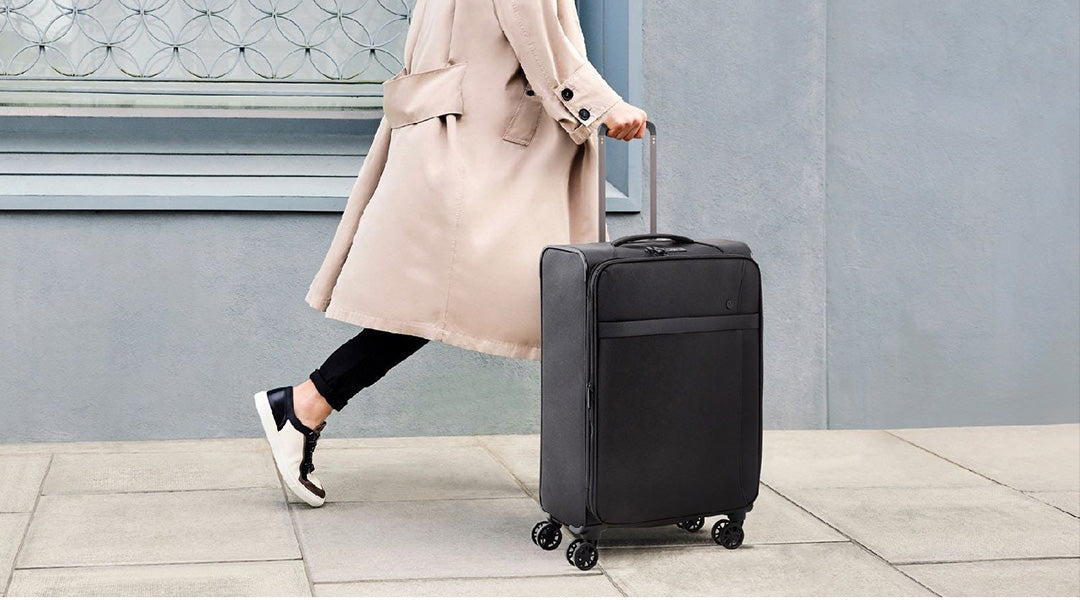 A stack of three different multi-colored detailed suitcases for things with  stickers. A blue new case, an orange leather vintage valise, and a cute  purple handbag. Elements for travel and vacation 22783324