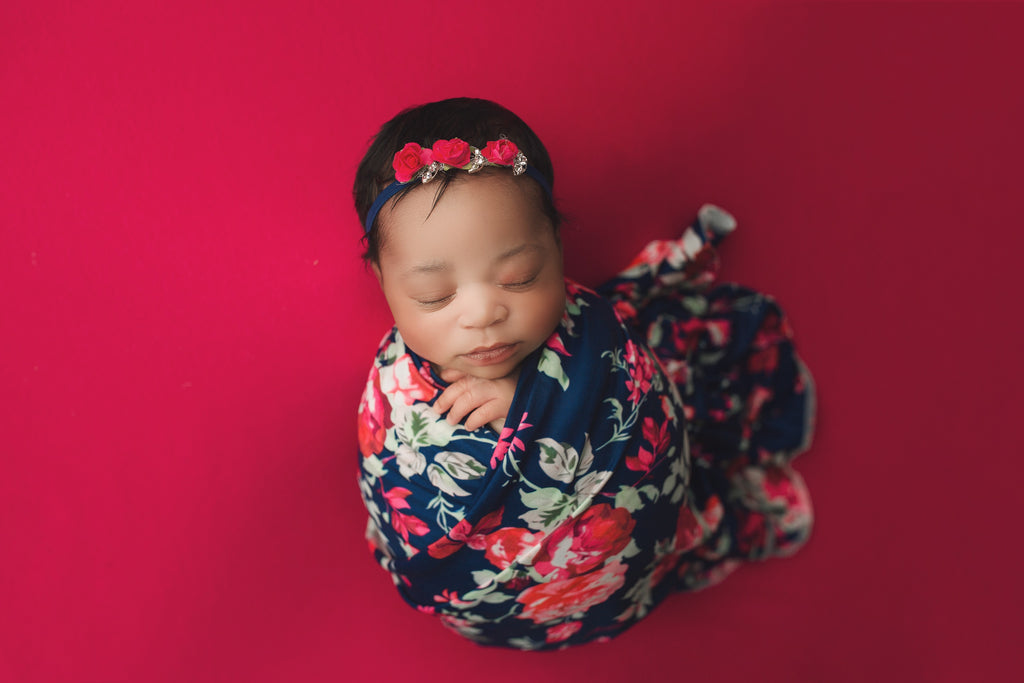 Red and floral baby blanket, symbolizing joy and lucky.