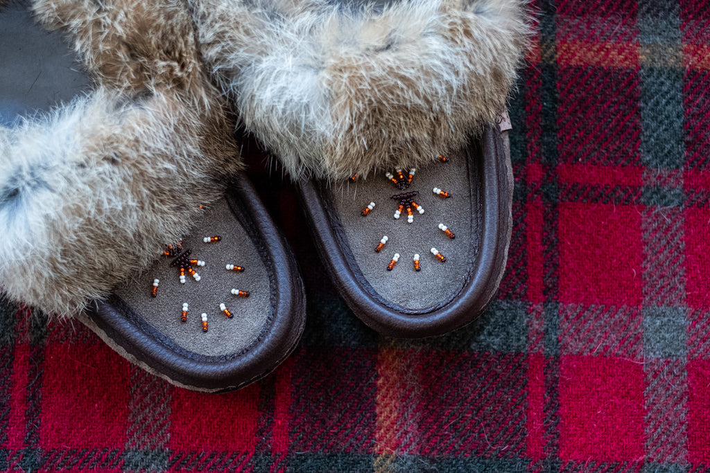 close-up of hand-beaded design on authentic rabbit fur moccasin slippers