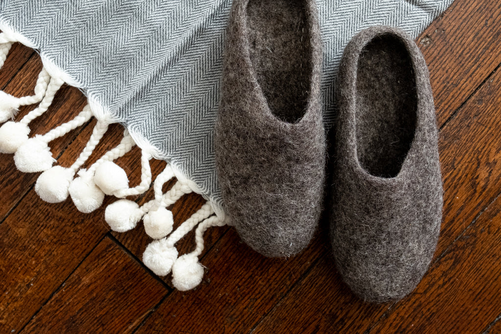 Felted house shoes are crafted entirely from wool, with a leather outsole