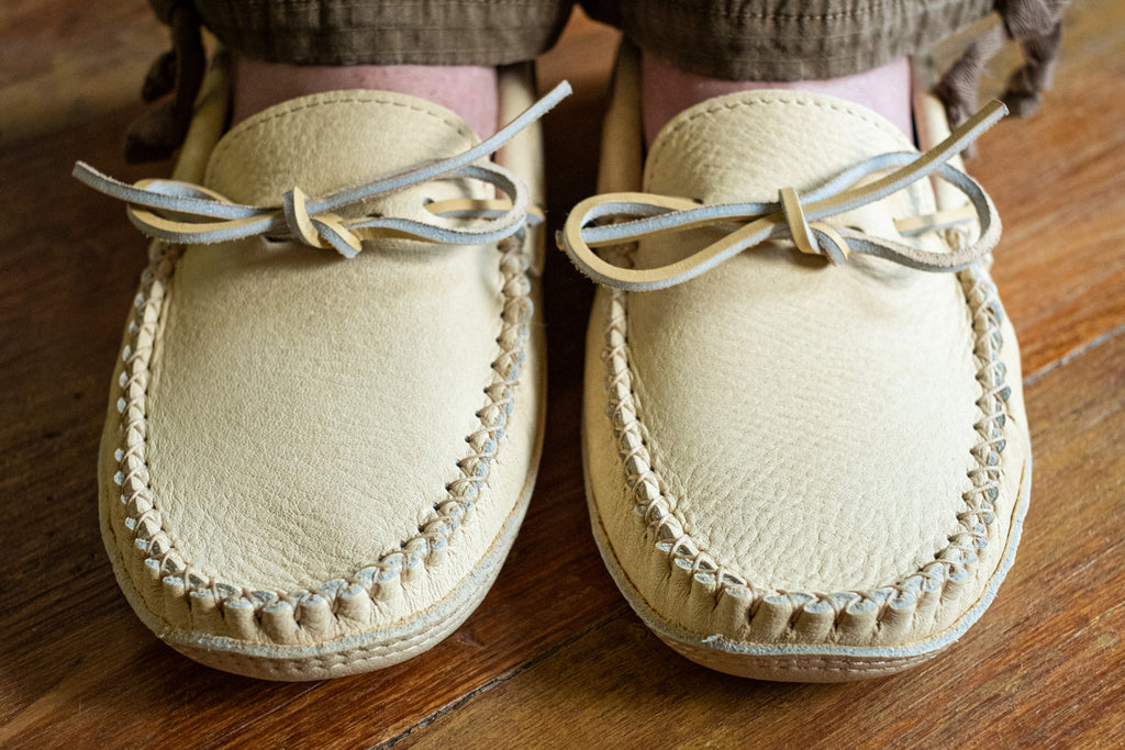 Hand-stitched vamp on a pair of quality genuine caribou leather moccasins