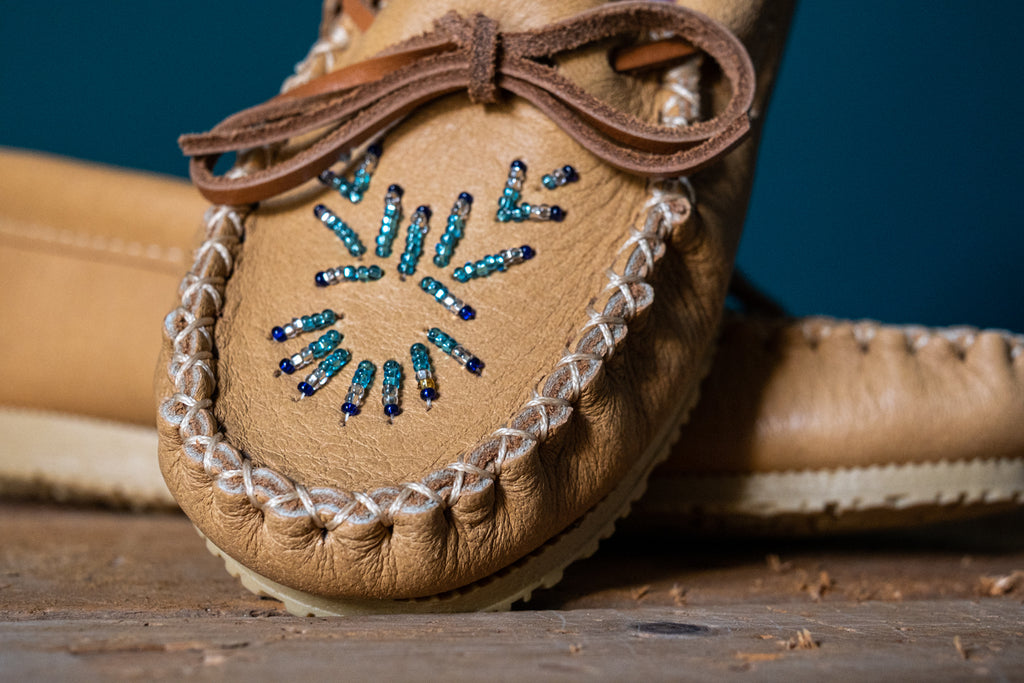close-up of hand-beaded design on a pair of authentic native american made moccasins