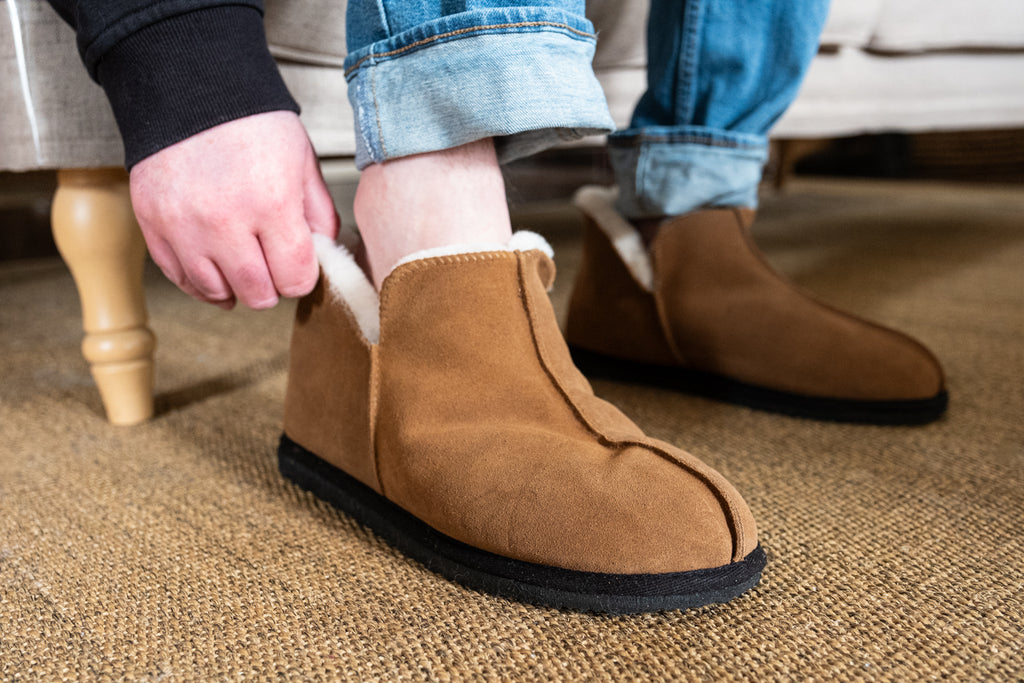 ankle-heigh sheepskin slipper that are easy to slide on and off with the open side dip
