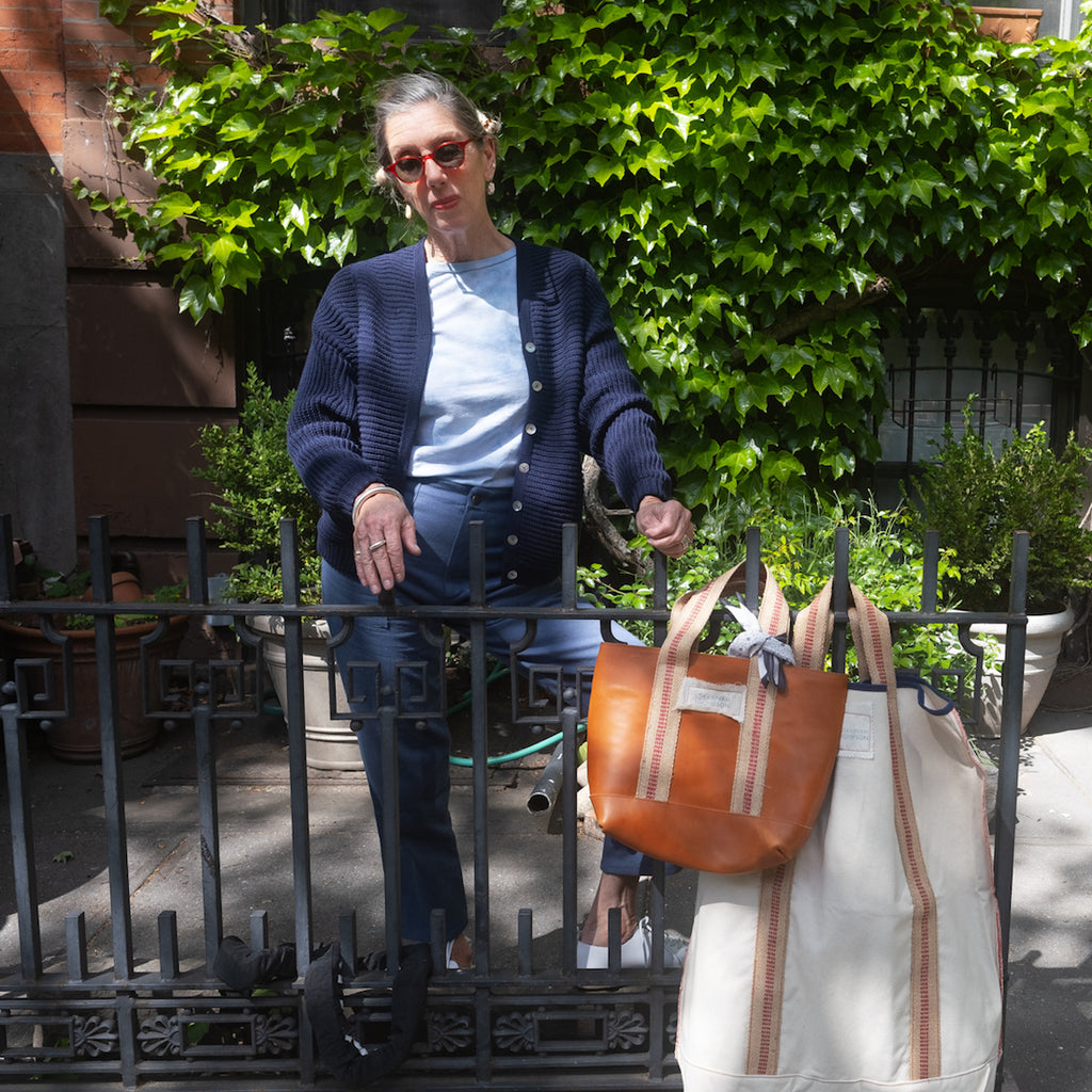 Susannah Thompson with her market bag and laundry bag wearing M.PATMOS Amelia Bomber