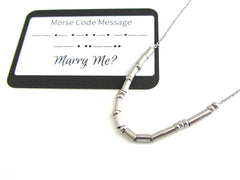 'Marry Me?' is spelt out using dots and dashes in this morse code stainless steel necklace