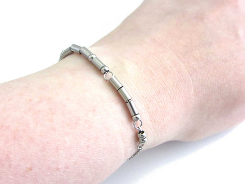 'I am enough' bracelet written in morse code stainless steel beads on a stainless steel chain worn on wrist for others to read