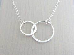 two sterling silver linked circles on a fine necklace chain