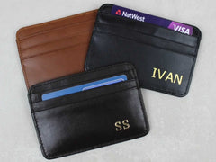 black, brown and tan credit card holders, one personalised with Ivan and one with initials SS